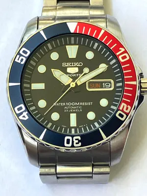 Seiko 5 SNZF15 Automatik, Zifferblatt mit blau-rotem Lünettenkranz von vorn
